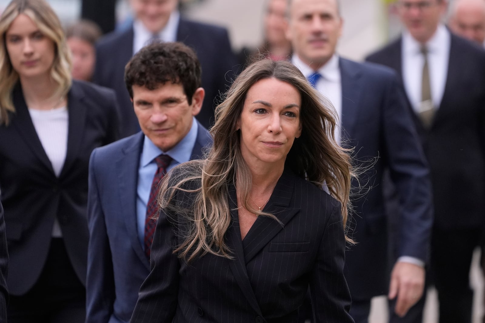 Karen Read arrives with her defense team for her trial at Norfolk Superior Court, Tuesday, April 22, 2025, in Dedham, Mass. (AP Photo/Charles Krupa)