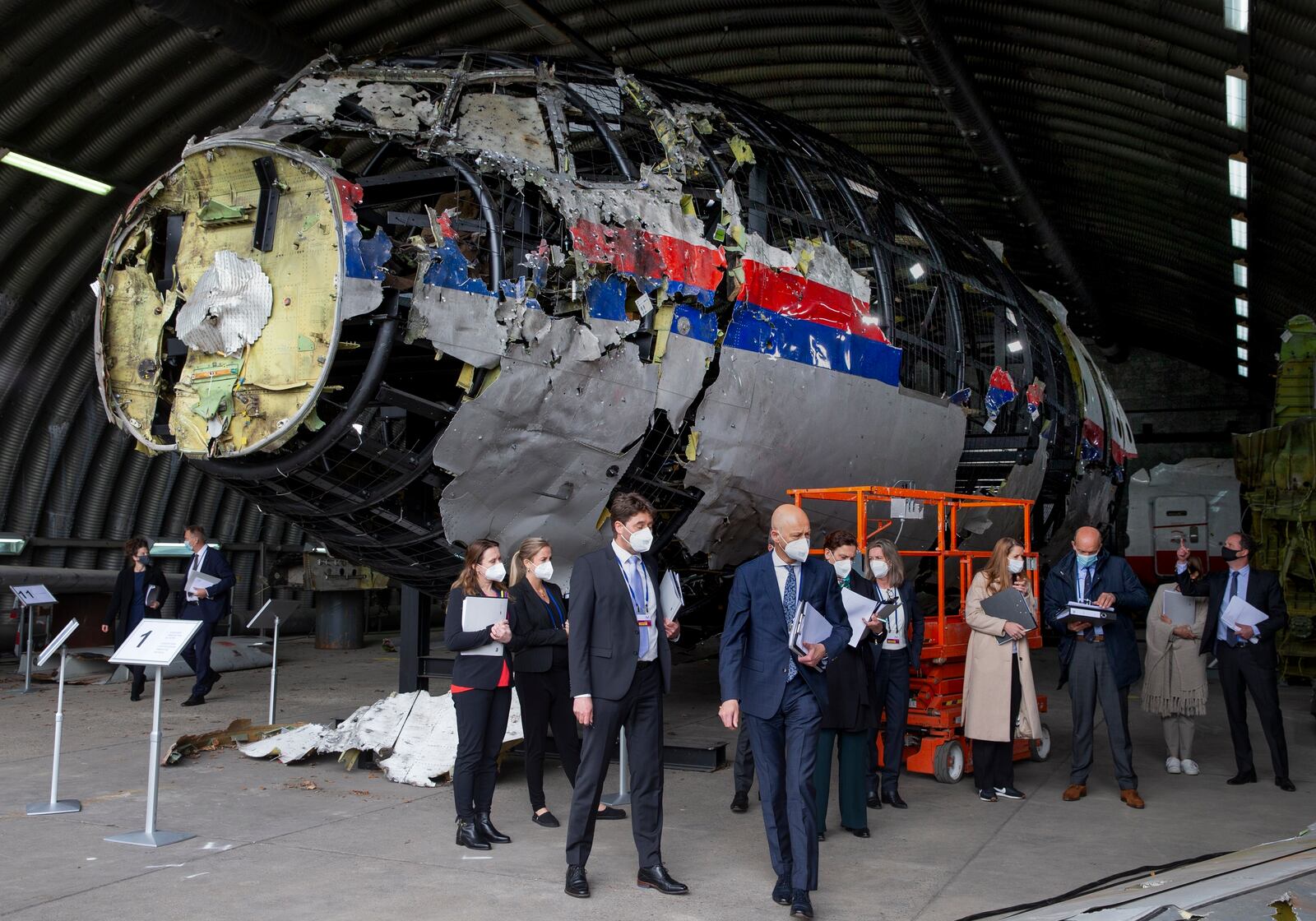 FILE - Judges and lawyers view the wreckage of a Malaysia Airlines passenger jet at the Gilze-Rijen Air Base, Netherlands, on May 26, 2021. (AP Photo/Peter Dejong, Pool, File)