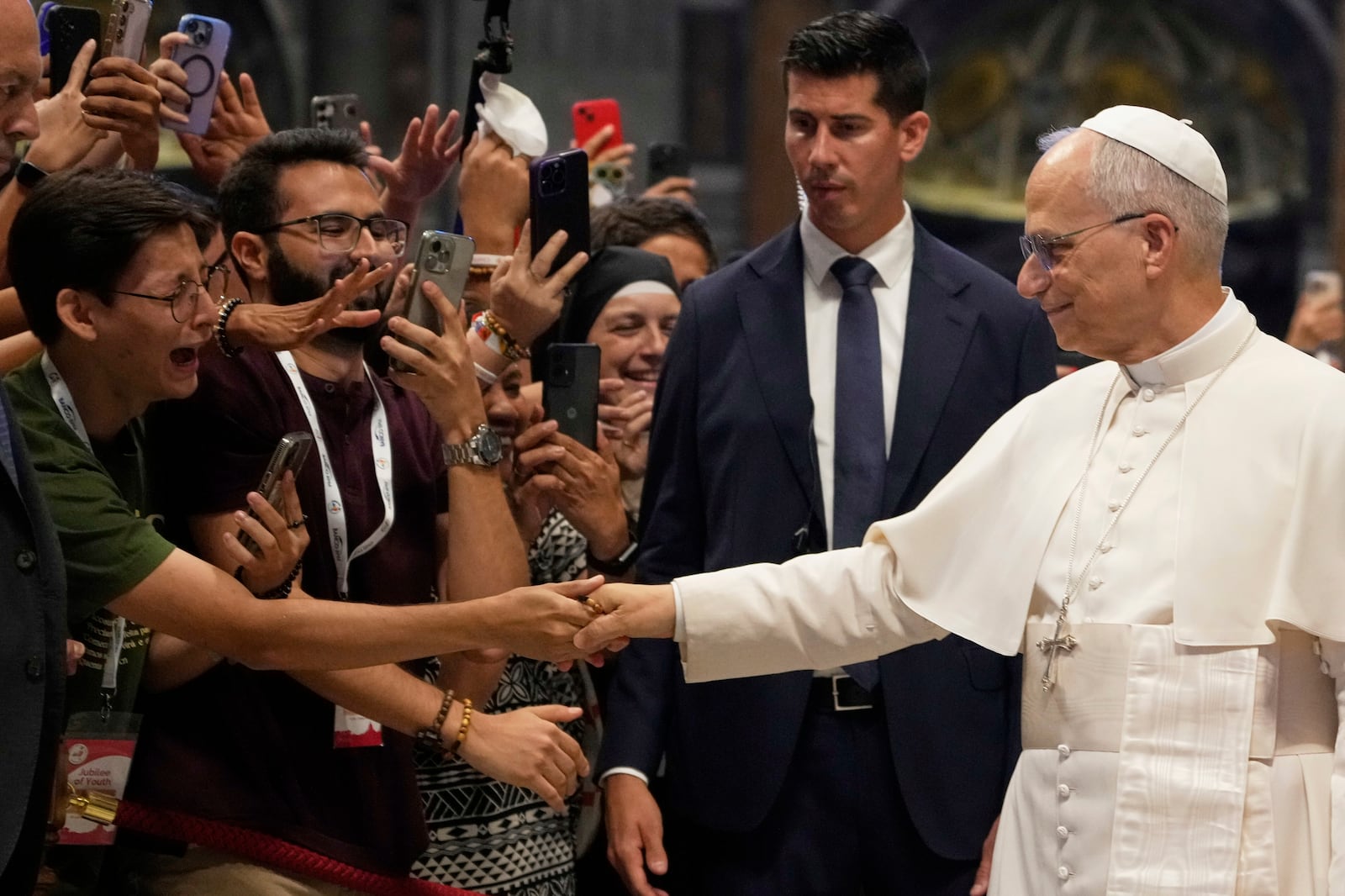 Pope Leo XIV greets faithful at the end of a mass celebrated by Cardinal Luis Antonio Tagle in St. Peter's Basilica on the occasion of the Youth Jubilee at the Vatican, Tuesday, July 29, 2025. (AP Photo/Gregorio Borgia)