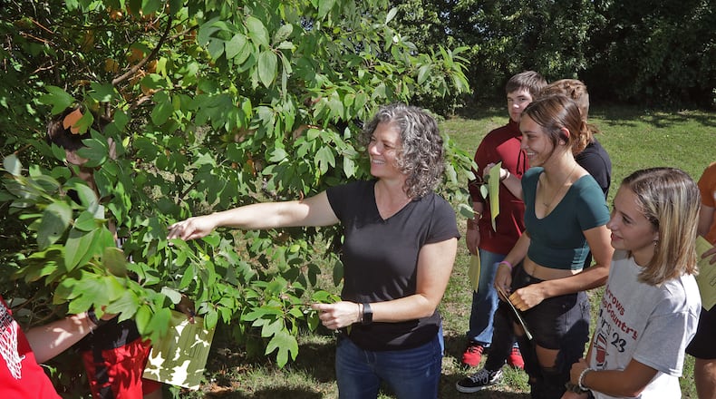 Angela Jones, Tecumseh High School science teacher, takes her conservation science class outside to identify plants. BILL LACKEY/STAFF