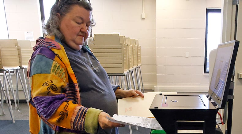 Jan Vaughan slides her ballot in the voting machine as she votes early at the Clark County Board of Elections Tuesday, March 12, 2024. BILL LACKEY/STAFF