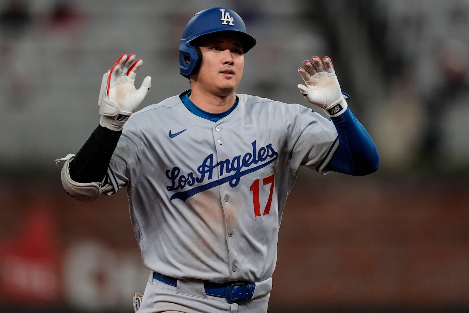 Los Angeles Dodgers two-way player Shohei Ohtani (17) celebrates his solo homer against the Atlanta Braves in the third inning of a baseball game, Saturday, May 3, 2025, in Atlanta. (AP Photo/Mike Stewart)