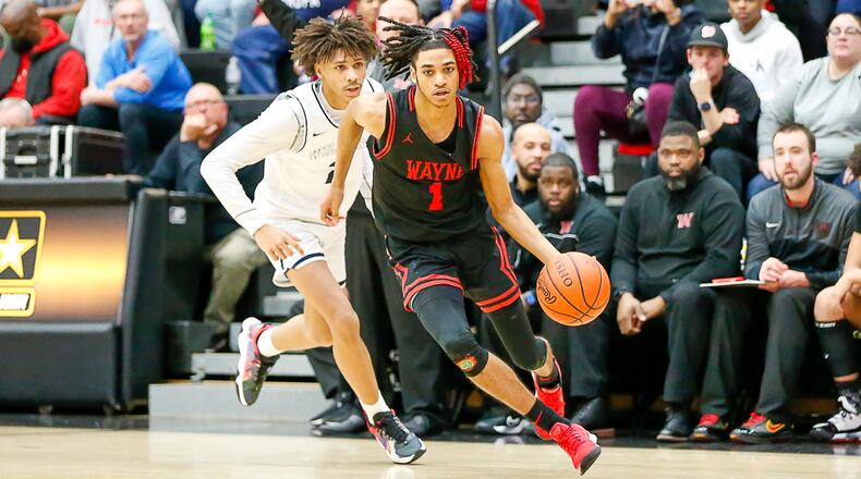 Wayne High School junior Lawrent Rice drives past Springfield's Eddie Muhammad during their game on Monday, Feb. 21 at Centerville High School. CONTRIBUTED PHOTO BY MICHAEL COOPER
