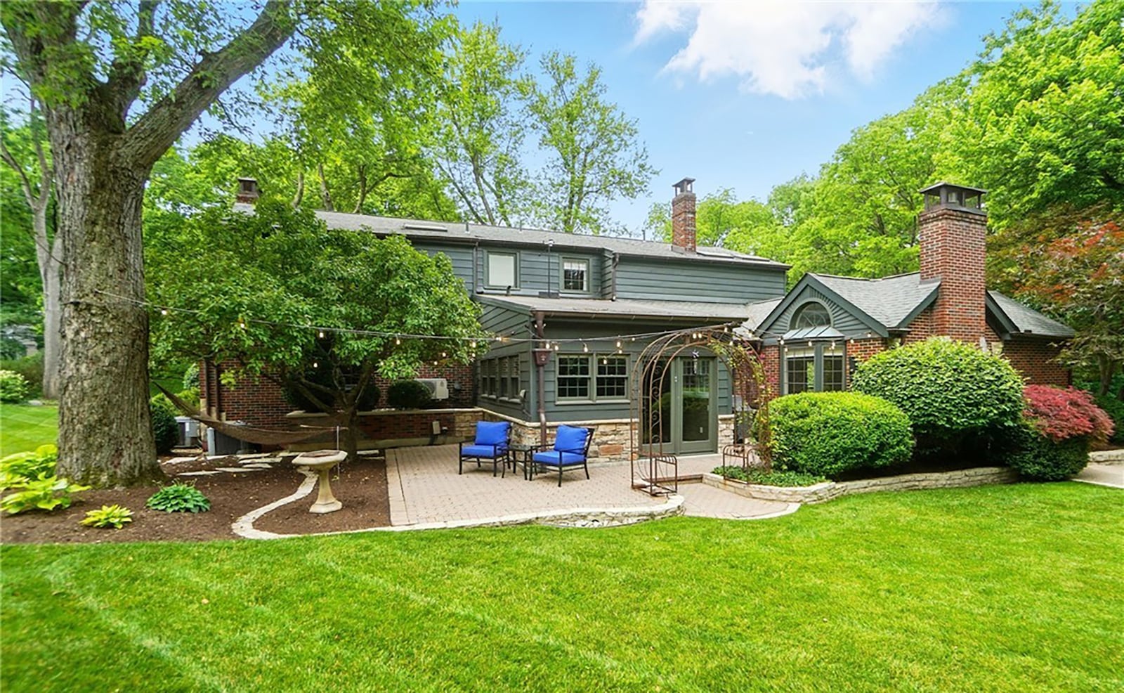 The rear of the home has a paver patio and composite deck and a newly built retaining wall.