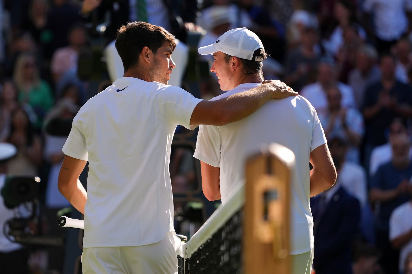 Carlos Alcaraz of Spain and Oliver Tarvet of Britain, right, chat after their second round men's singles match at the Wimbledon Tennis Championships in London, Wednesday, July 2, 2025.(AP Photo/Kirsty Wigglesworth)