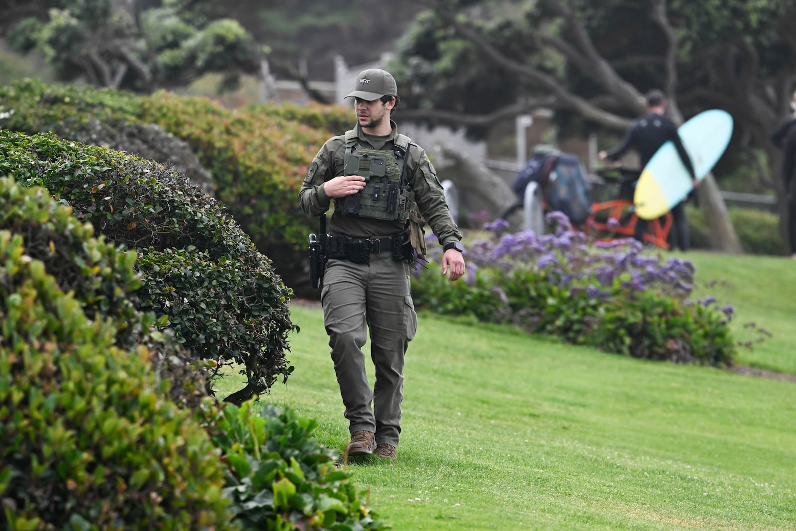 A U.S. Border Patrol agent searches Seagrove Park in Del Mar after a boat capsized Monday, May 5, 2025, at Torrey Pines State beach in San Diego, Calif. (AP Photo/Denis Poroy)
