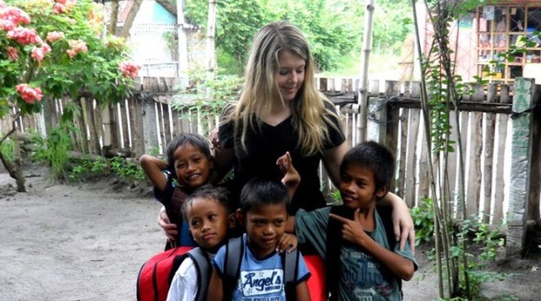 Meredith Wood poses with four of the fourteen children that currently live at her orphanage in General Santos City, Philippines. Contributed photo