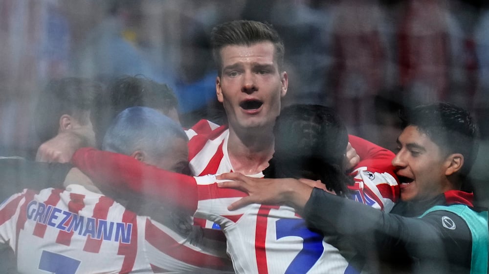 Atletico Madrid's Alexander Sorloth, center, celebrates after scoring his side's third goal during the Champions League play-off second leg soccer match between Atletico Madrid and Club Brugge, in Madrid, Spain, Tuesday, Feb. 24, 2026. (AP Photo/Manu Fernandez)