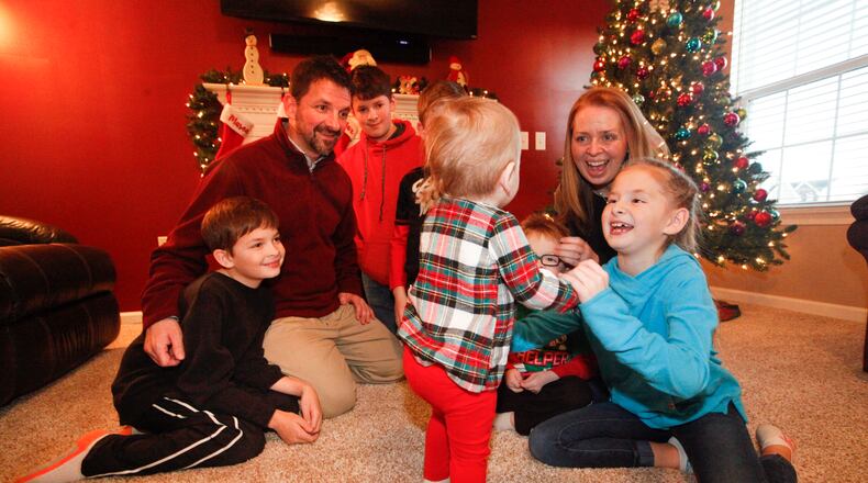 Christie and Brian Looney of Huber Heights helped a drug-exposed baby through withdrawal after becoming foster parents in 2015. Their third foster child, pictured, a 19-month-old, will soon become their adopted daughter and sister to their five biological children: Mason, 13, Myles, 11, Max, 10, Mae, 9, and Maddie, 4. CHRIS STEWART / STAFF
