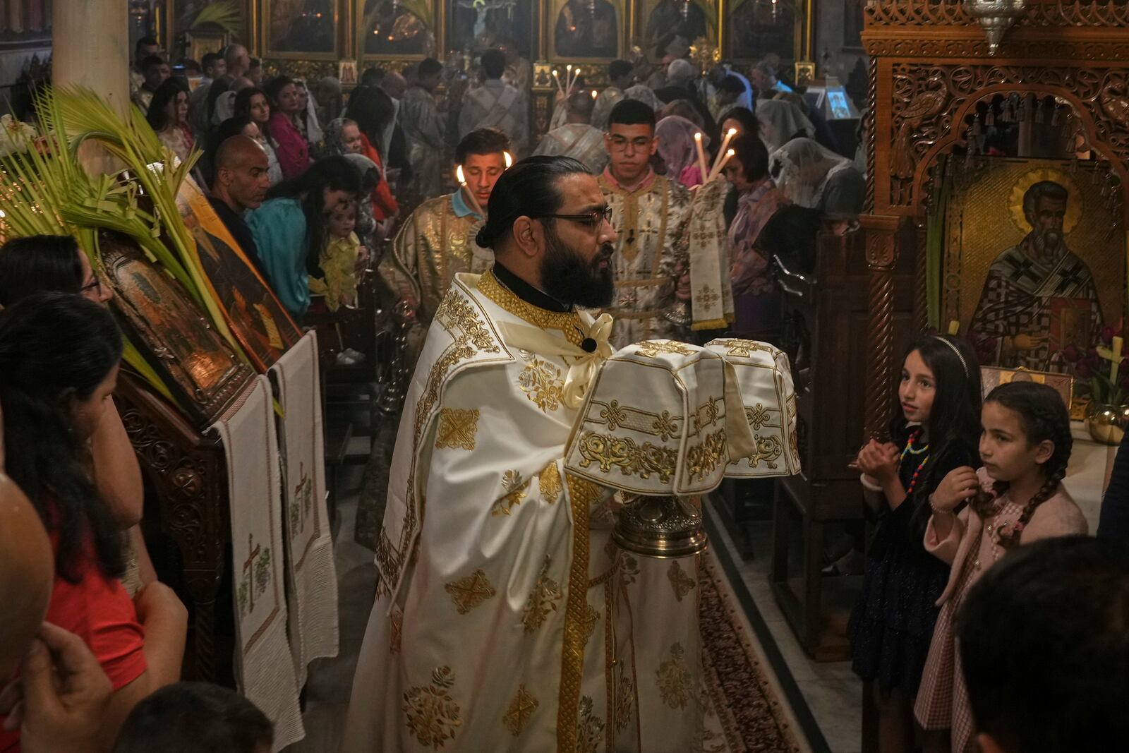 Palestinian Christians attend a Palm Sunday mass at the Greek Orthodox Church of Saint Porphyrius in Gaza City, Sunday, April 13, 2025. (AP Photo/Jehad Alshrafi)