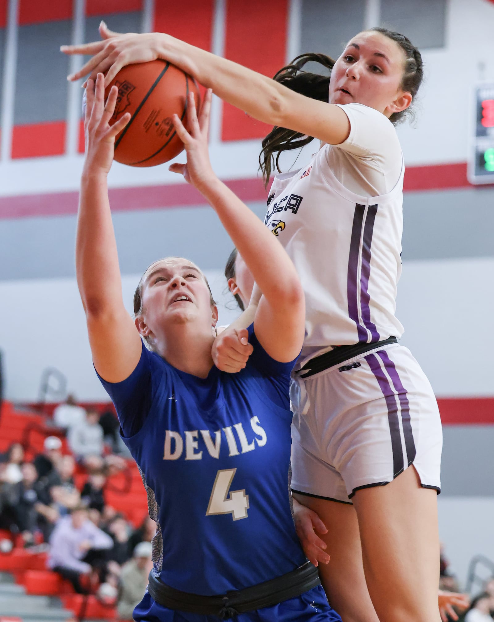 Brookville freshman forward Lucy Hoover shoots with pressure from Cincinnati Hills Christian Academy's Shae Born during a Division IV district final on Saturday, Feb. 28 at Troy High School's Trojan Activities Center. BRYANT BILLING / STAFF