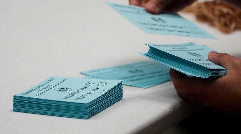 FILE - A volunteer sorts votes on a new contract offer from Boeing, Nov. 4, 2024, at the IAM District 751 Union Hall in Seattle. (AP Photo/Lindsey Wasson, File)