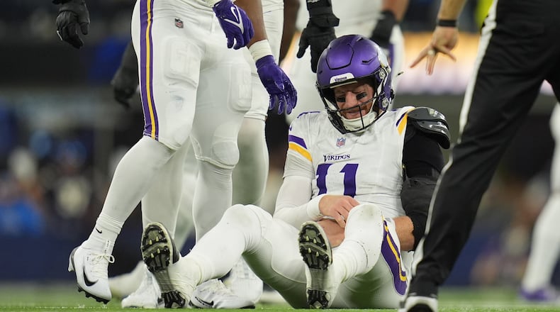 Minnesota Vikings quarterback Carson Wentz (11) sits on the ground after a hit during the second half of an NFL football game against the Los Angeles Chargers Thursday, Oct. 23, 2025, in Inglewood, Calif. (AP Photo/Gregory Bull)
