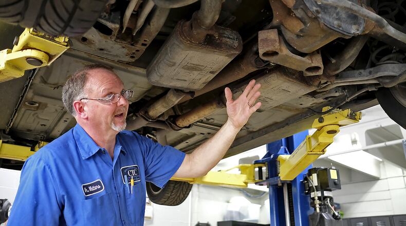 Stephen Walters, a teacher at Springfield/Clark Career Technical Center, explains what is wrong with a car in his lab. Walters is one of the four teachers of the year.