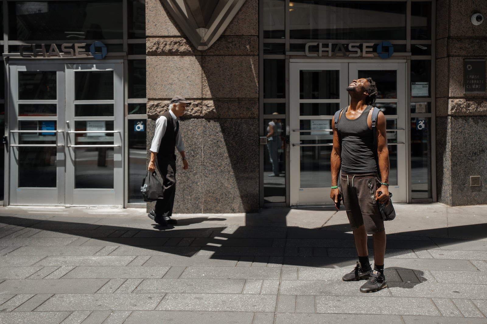 A man squints at the sun during a heatwave on Tuesday, June 24, 2025, in New York. (AP Photo/Olga Fedorova)