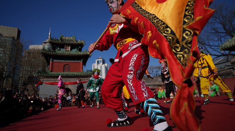 Dancers in colorful costumes perform Yingge Dance, a traditional folk dance from southern China during Lunar New Year celebrations in Beijing, China, Tuesday, Feb. 17, 2026. (AP Photo/Vincent Thian)