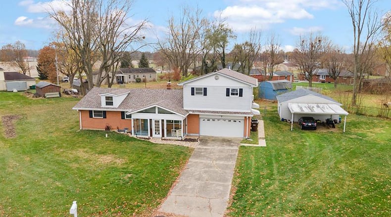 The front of the home has a two-car attached garage, a fully enclosed and covered front porch and a carport attached to the detached garage. Contributed photos