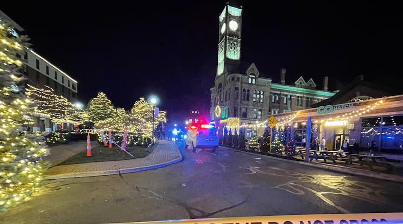 The area around Springfield’s downtown Esplanade was taped off as a crime scene after a man was reportedly shot in the parking lot of the Clark County Heritage Center Friday night following the Holiday in the City celebration. BILL LACKEY/STAFF