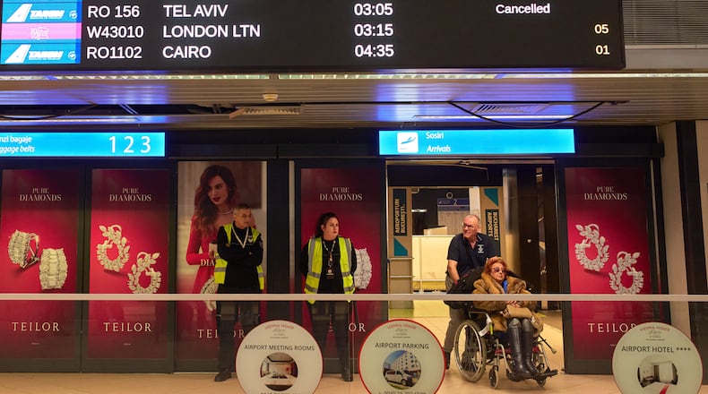 A display in the arrivals terminal of the Henri Coanda International Airport shows cancelled flights originating in Middle East countries, in Otopeni, Romania, Tuesday, March 3, 2026. (AP Photo/Vadim Ghirda)