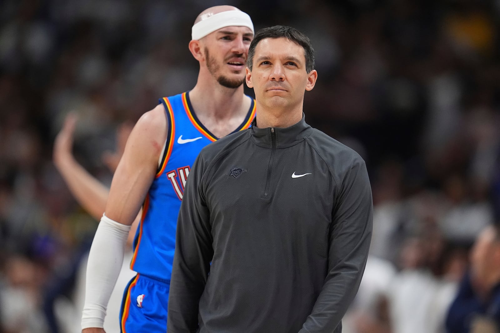 Oklahoma City Thunder head coach Mark Daigneault, front, heads to confer with assistant coaches during a time out as guard Alex Caruso argues with a referee after being called for a foul in the second half of Game 6 in the Western Conference semifinals of the NBA basketball playoffs against the Denver Nuggets Thursday, May 15, 2025, in Denver. (AP Photo/David Zalubowski)