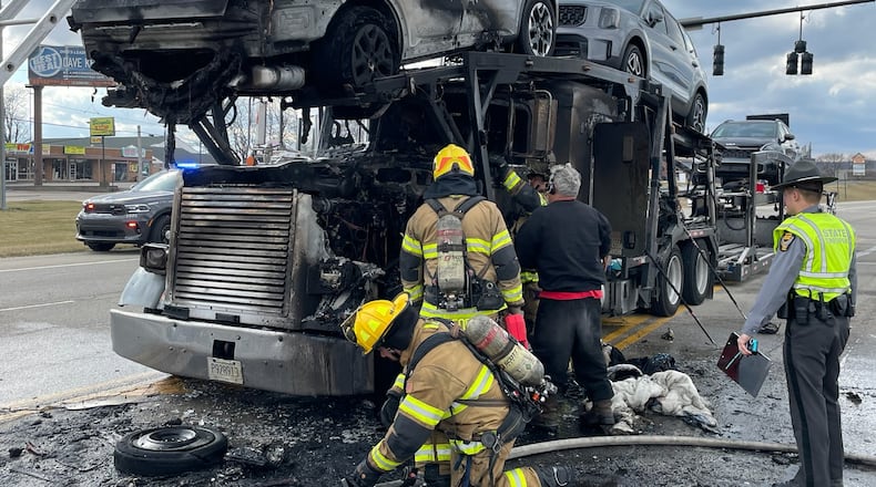 A tractor-trailer rig carrying Kia vehicles caught fire Thursday afternoon on Troy Road near Hillcrest Avenue. BILL LACKEY/STAFF