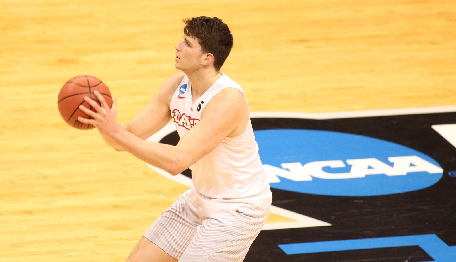 Dayton’s Sam Miller shoots against Wichita State in the first round of the NCAA tournament on March 17, 2017, at Bankers Life Fieldhouse in Indianapolis. David Jablonski/Staff