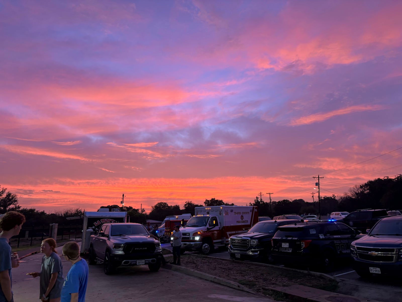 The sun sets as flooding victims gather at the Ingram, Texas, Elementary School at 8:55 p.m. on Friday, July 4, 2025. (Shabd Simon-Alexander via AP)