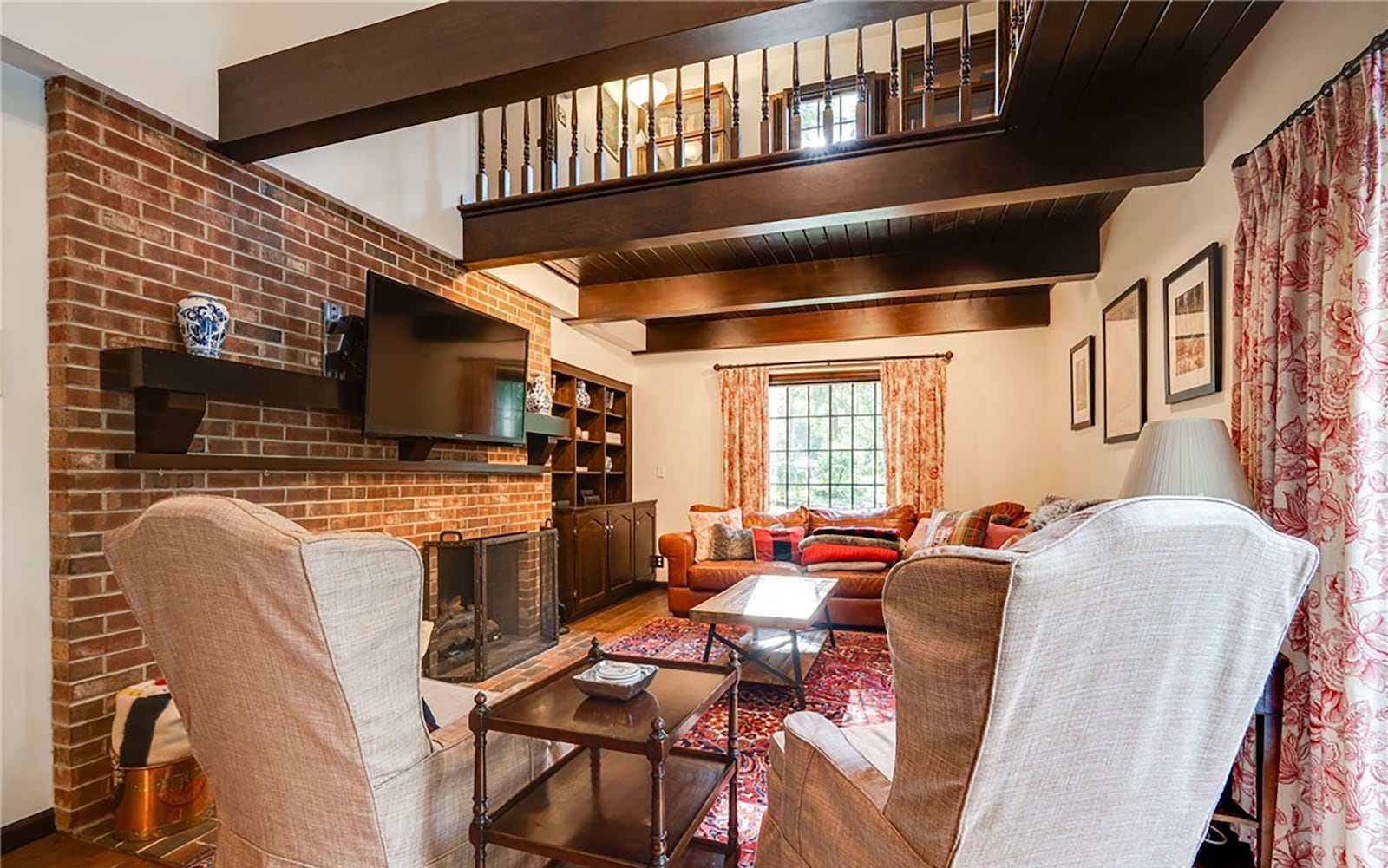 The family room has a wood beamed ceiling and the second floor study overlooks it. There is a brick fireplace and recessed lighting. CONTRIBUTED