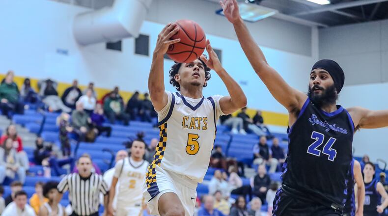 Springfield High School junior Charles Cunningham drives to the hoop against Springboro senior Yuvi Bimwal during their game on Tuesday night in Springfield. The Wildcats won 67-55. Michael Cooper/CONTRIBUTED