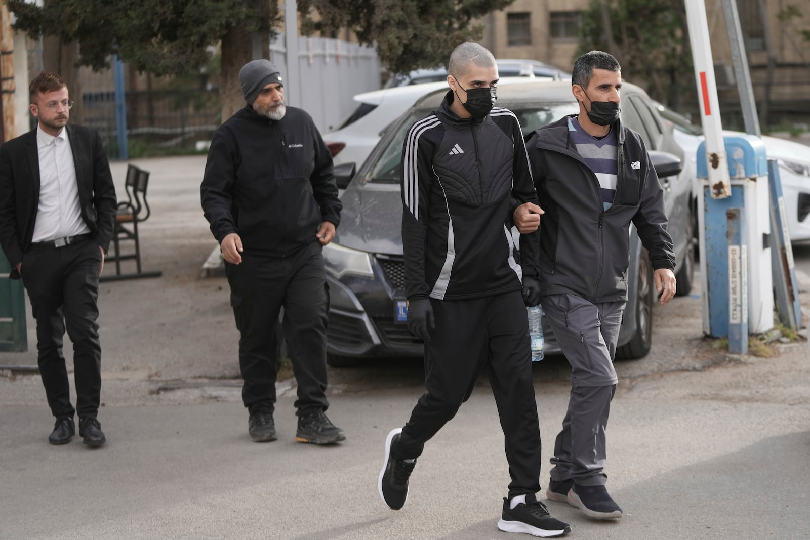Palestinian Ahmed Manasra, second right, who took part in an attack in 2015 when he was 13 and developed schizophrenia in prison, walks upon his release in Jerusalem, Thursday, April 10, 2025. (AP Photo/Mahmoud Illean)