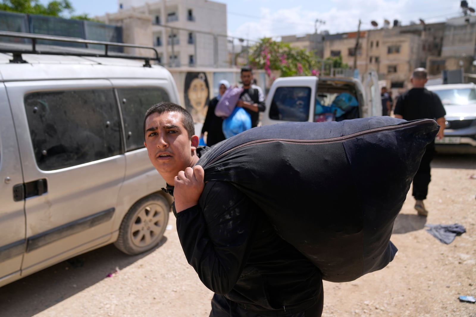 Residents of the now evacuated refugee camp of Tulkarem return to collect belongings before the destruction of their homes as Israeli forces prepare to carry out the demolition of 116 homes across the two refugee camps of the Israeli occupied West Bank city of Tulkarem, Friday, May 2, 2025. (AP Photo/Nasser Nasser)