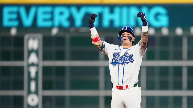 Italy's Andrew Fischer celebrates after hitting a two-run double during the fourth inning of a World Baseball Classic quarterfinal game against Puerto Rico, Saturday, March 14, 2026, in Houston. (AP Photo/Karen Warren)