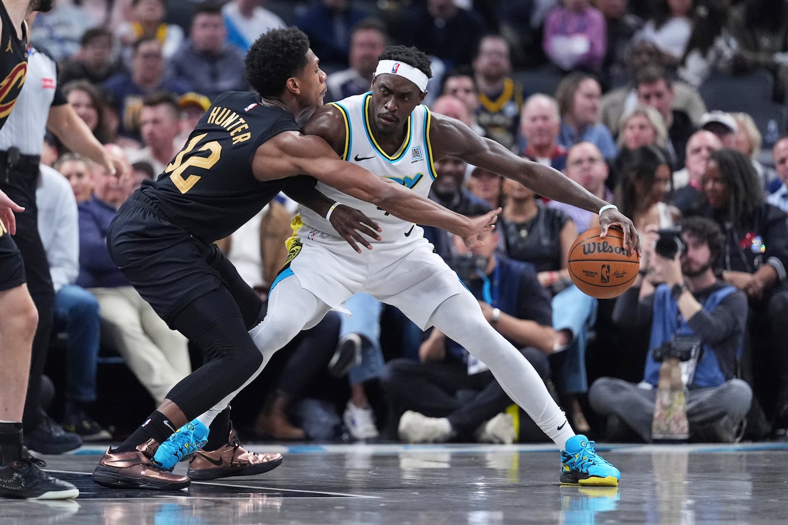Indiana Pacers forward Pascal Siakam (43) drives on Cleveland Cavaliers forward De'Andre Hunter (12) during the first half of an NBA basketball game in Indianapolis, Thursday, April 10, 2025. (AP Photo/Michael Conroy)