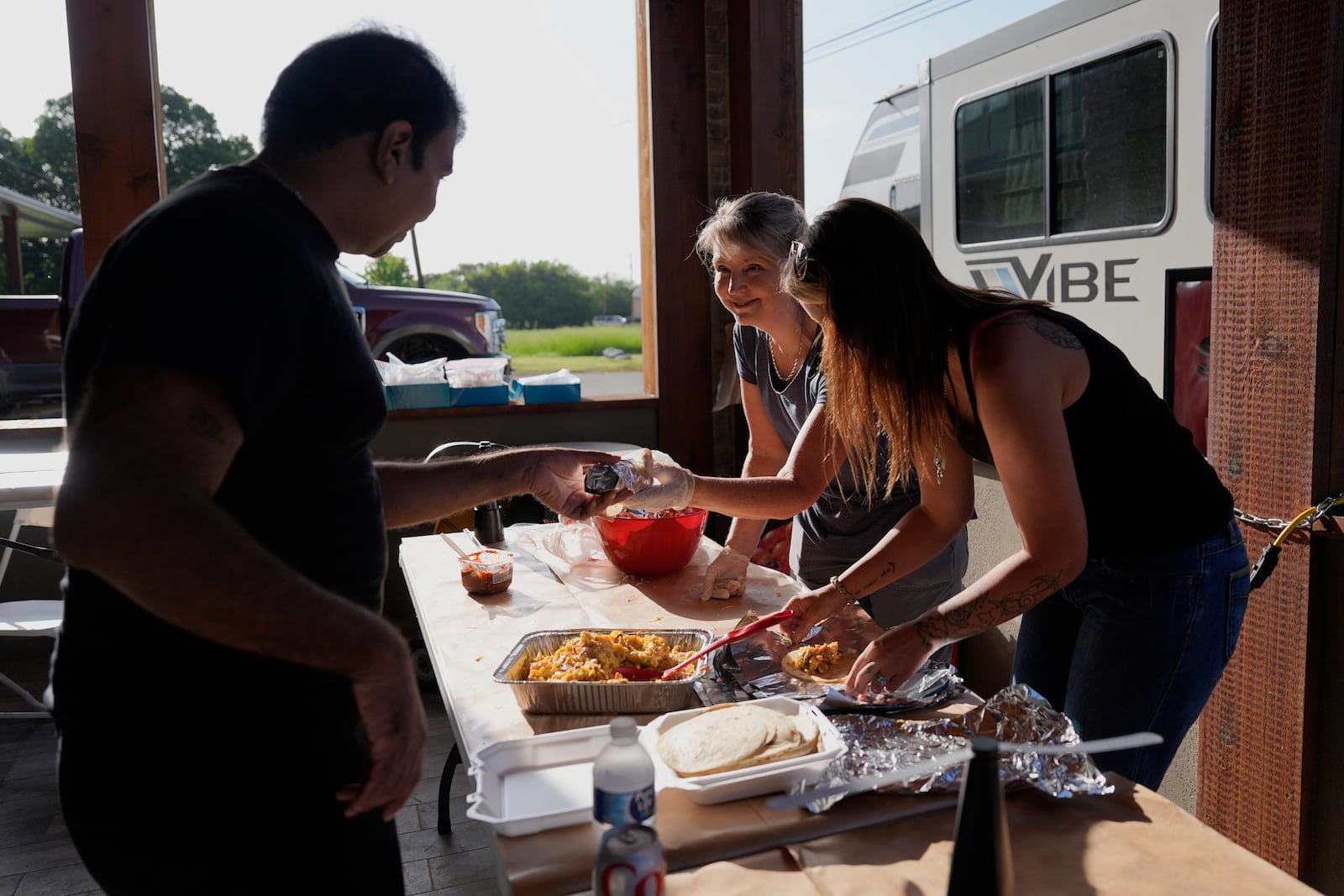 Audrey Ethridge and Briana Virden, right, help feed first responders and volunteers in Comfort, Texas on Thursday, July 10, 2025. (AP Photo/Ashley Landis)