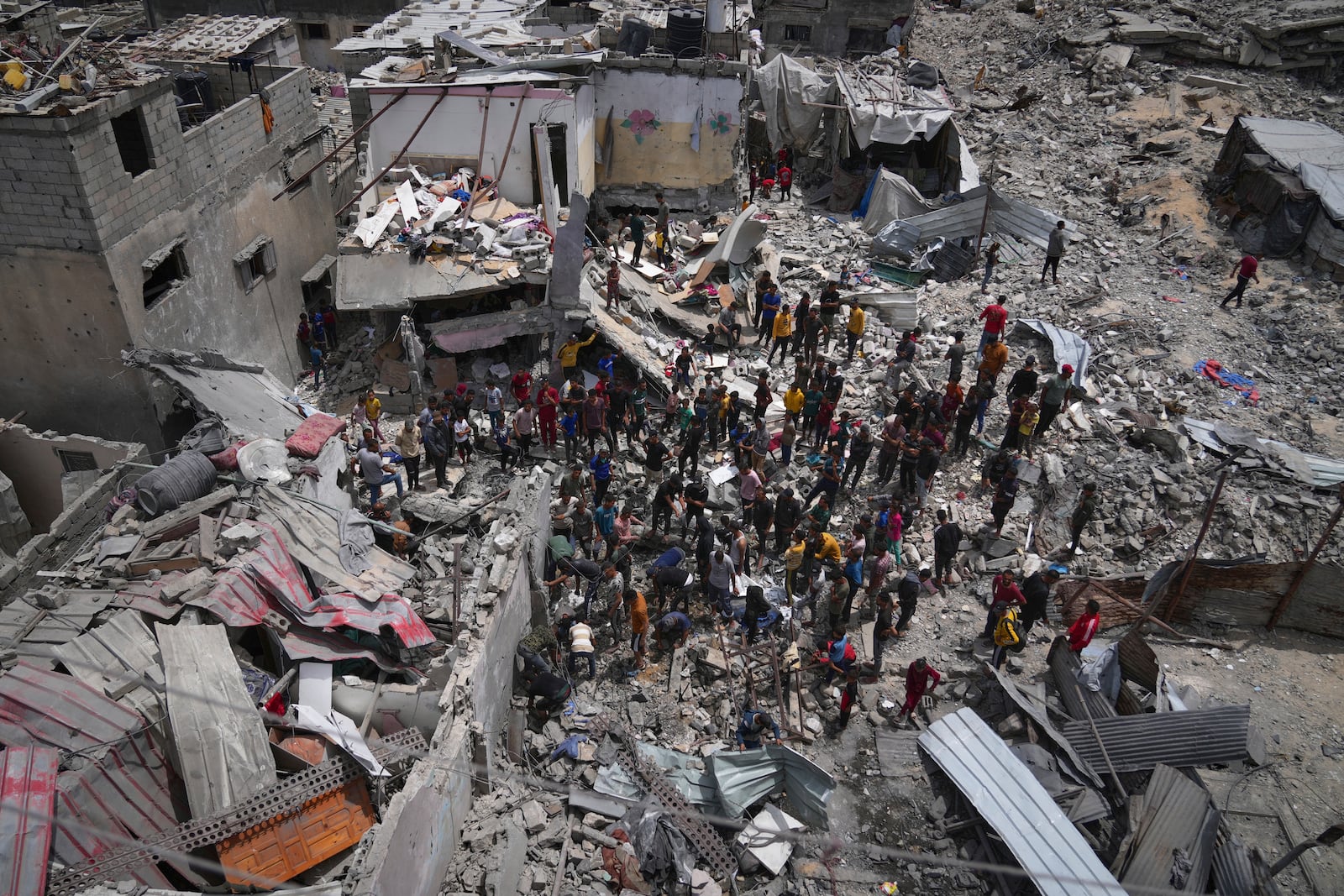 Palestinians search the rubble of a house targeted by an Israeli army strike that killed at least five people in Khan Younis, in the southern Gaza Strip, on Thursday, May 1, 2025. (AP Photo/Abdel Kareem Hana)
