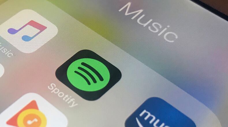 FILE - This Sunday, Jan. 28, 2018, photo shows music streaming apps clockwise from top left, Apple, Spotify, Amazon, Pandora and Google on an iPhone in New York. (AP Photo/Jenny Kane, File)