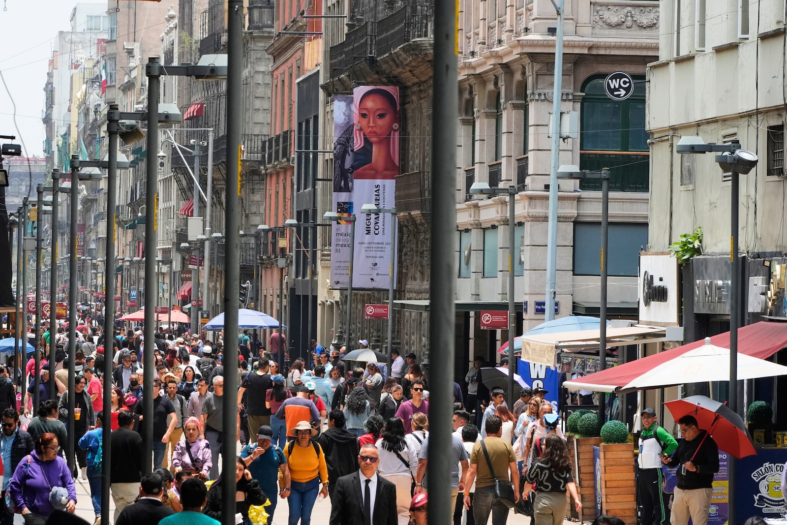 Pedestrians traverse Francisco I. Madero Avenue in downtown Mexico City, Thursday, July 10, 2025. (AP Photo/Fernando Llano)