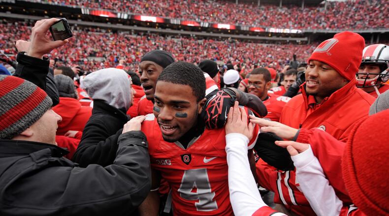 COLUMBUS, OH - NOVEMBER 24: C.J. Barnett #4 of the Ohio State Buckeyes is congratulated by fans after Ohio State defeated the Michigan Wolverines 26-21 at Ohio Stadium on November 24, 2012 in Columbus, Ohio. (Photo by Jamie Sabau/Getty Images)