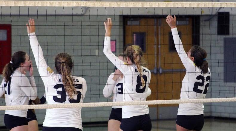 Shawnee’s Tori Huxley (21), Reagan Simpson (35), Taylor Edwards (8) and Ashley Dingeman (22) celebrate an ace from Gabby Thornton. CONTRIBUTED PHOTO