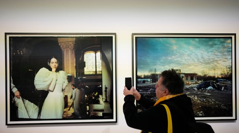 A visitor takes a picture of a portrait of actress Emma Stone at an exhibition of images by Oscar nominated director Yorgos Lanthimos at Onassis Stegi in Athens, Greece, on Friday, March 6, 2026. (AP Photo/Thanassis Stavrakis)