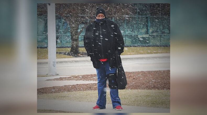 A man waited for the bus on Patterson Boulevard on a snowy morning on Thursday, Jan. 28, 2021. MARSHALL GORBY\STAFF