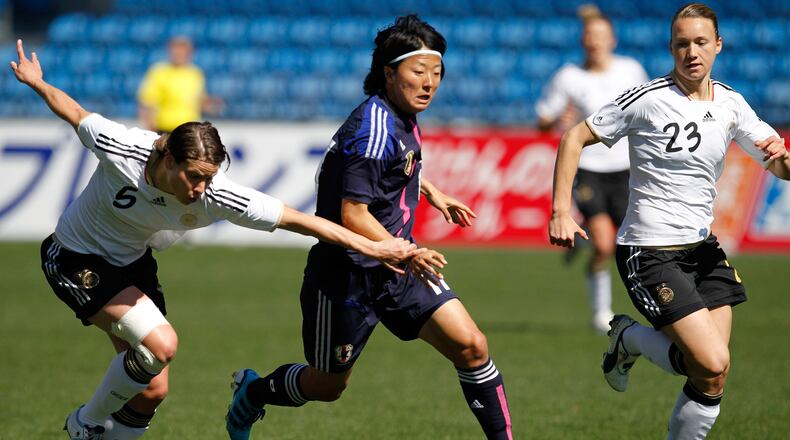In this March 7, 2012, file photo, Japan's Yuki Nagasato, center, challenges Germany's Annike Krahn, left, and Josephine Henning during the Algarve Cup women's soccer final match at the Algarve stadium outside Faro, southern Portugal. Nagasato won the Women's World Cup with Japan in 2011 and currently plays for the Chicago Red Stars in the NWSL. Now she is joining the Japanese men's club Hayabusa Eleven on loan. (AP Photo/Armando Franca, File)