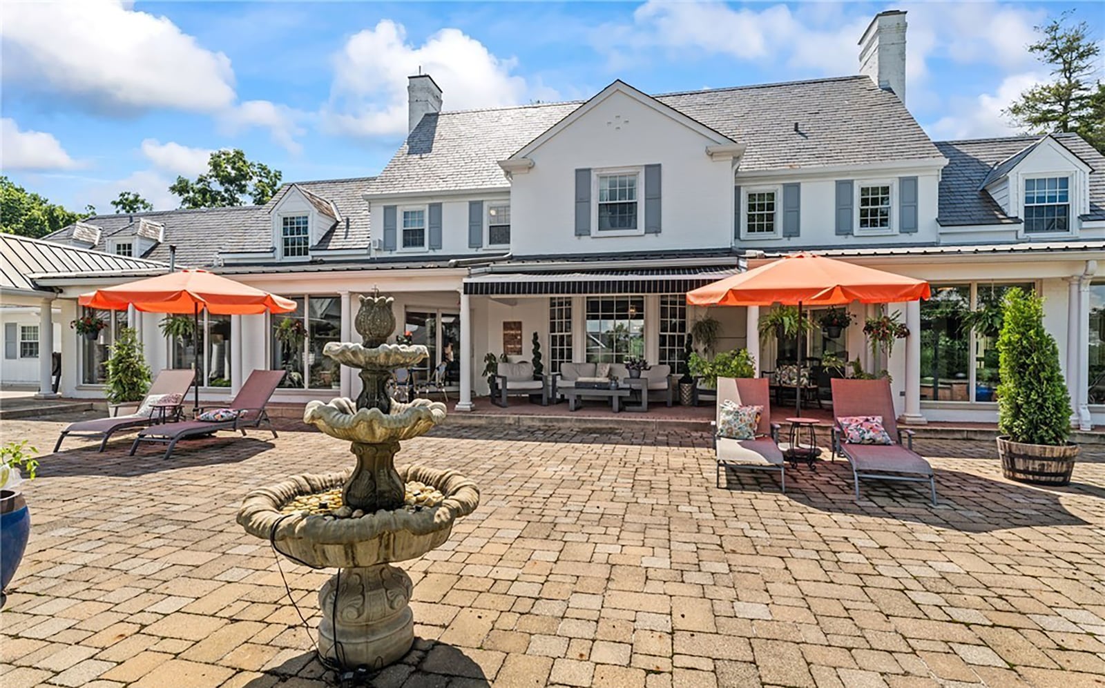 The rear paver patio spans most of the rear of the home and features a covered area, a retractable awning, built in fountain and outdoor fireplace. CONTRIBUTED