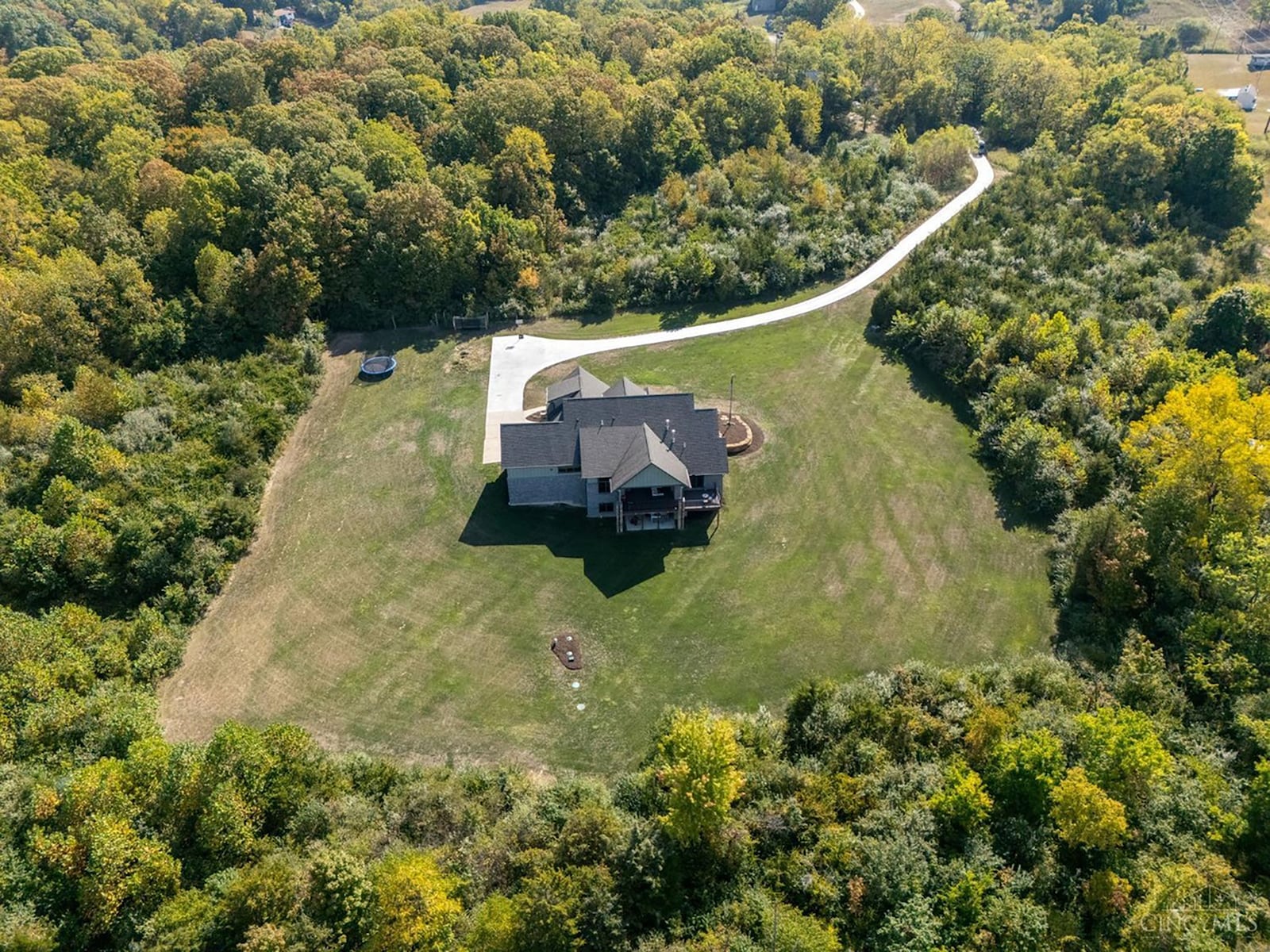 The rear of the home overlooks the two acres of lawn that is surrounded by woods. CONTRIBUTED