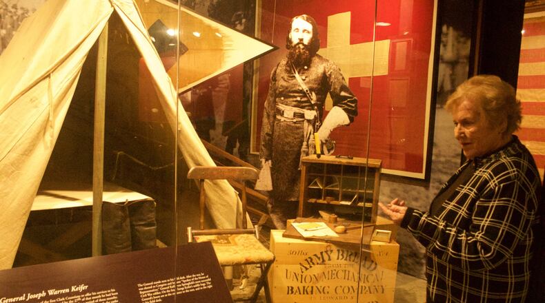 Ardath Dellapina, a program director at the Clark County Historical Society stands next to an exhibit about Springfield native J. Warren Kiefer. HASAN KARIM/ Staff