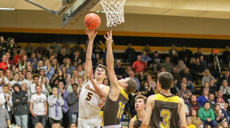 Shawnee High School junior Isaac Siemon shoots the ball over Kenton Ridge’s Calvin Dibert during their game on Friday night. The Braves won 58-48. CONTRIBUTED PHOTO BY MICHAEL COOPER