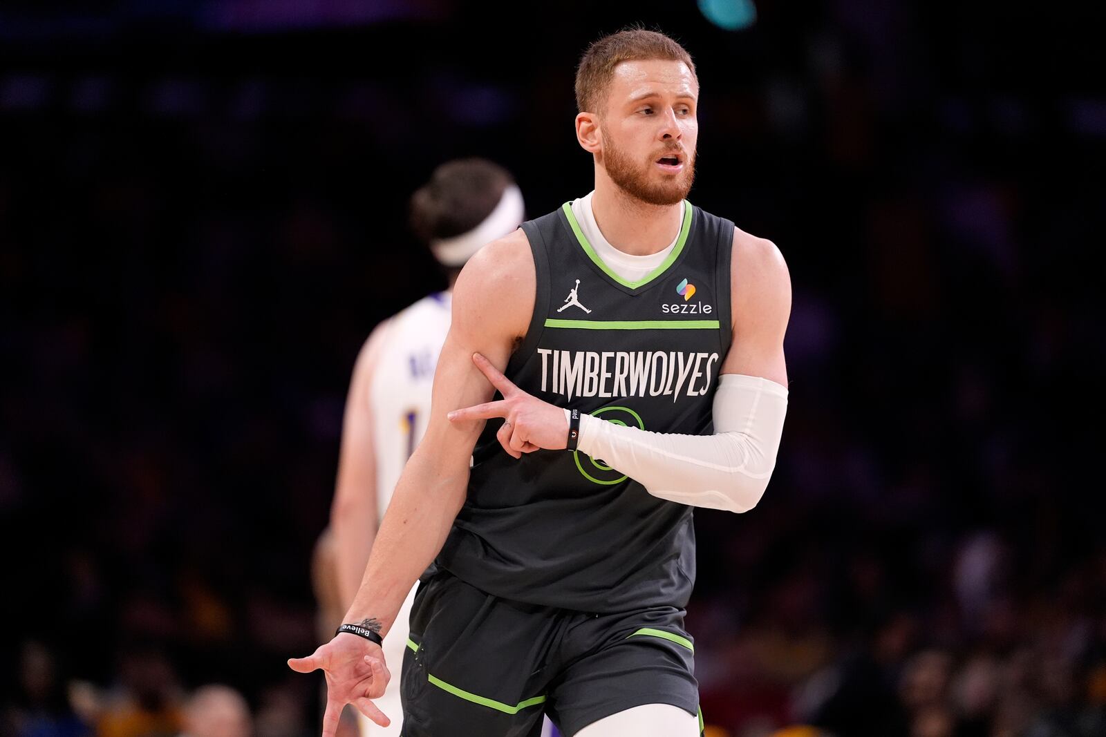 Minnesota Timberwolves guard Donte DiVincenzo gestures after making a three-point shot during the first half in Game 1 of an NBA first-round playoff series against the Los Angeles Lakers, Saturday, April 19, 2025, in Los Angeles. (AP Photo/Mark J. Terrill)