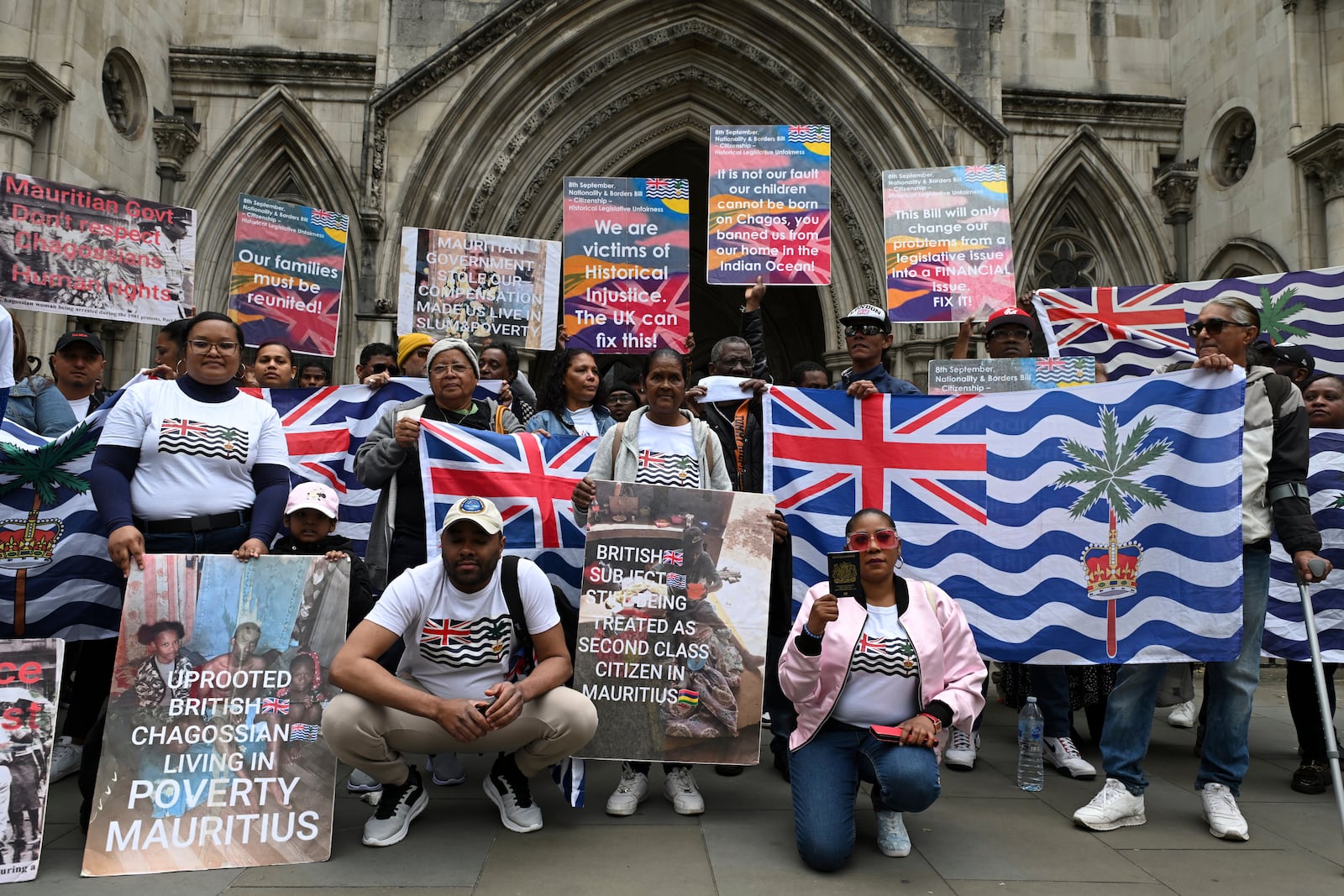People demonstrate outside the High Court in London, Thursday, May 22, 2025, after a British court blocked the U.K. from transferring sovereignty over the Chagos Islands to Mauritius hours before the agreement was due to be signed. (AP Photo/Thomas Krych)