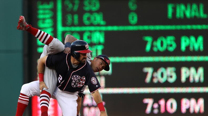 The Nationals’ Adam Eaton and the Cardinals’ Kolten Wong get tangled up after Eaton slid into second in an attempt to break up a double play during the eighth inning at Nationals Park on April 12, 2017 in Washington, DC. (Photo by Patrick Smith/Getty Images)