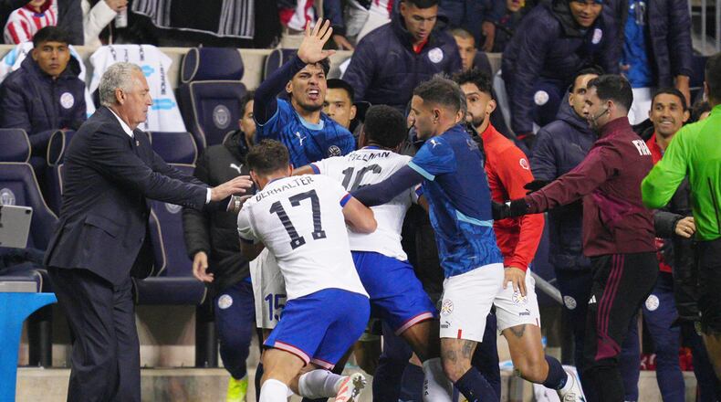 Paraguay's Gustavo Gomez (15), United States' Sebastian Berhalter (17) and Alex Freeman (16) and Paraguay's Antonio Sanabria scuffle on the sidelines during the second half of an international friendly soccer match, Saturday, Nov. 15, 2025, in Chester, Pa. (AP Photo/Derik Hamilton)